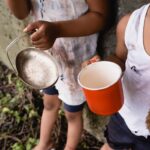 cropped-view-of-homeless-african-american-kids-holding-cup-and-metal-plate-while-begging-alms-on